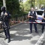 French hooded police officers guarded the area with other police officers after a knife attack Thursday in Trappes, west of Paris.