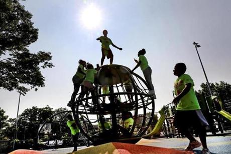 Children from Shelburne Summer Camp went high for a spin on a rotating rope sphere at the renovated Ramsay Park.
