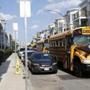 A student walked past school buses outside Codman Academy in Dorchester on Wednesday. 