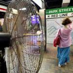 BOSTON, MA - 8/29/2018:COOL BREEZE.... Karen Payne, who is from Florida on a visit to Boston and should be use to humid weather lifts her hair off the back of her neck to keep cool from a fan at Park Street Station Greenline. (David L Ryan/Globe Staff ) SECTION: METRO TOPIC stand alone photo