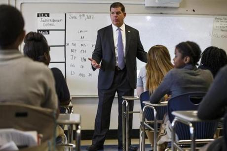 Boston Mayor Marty Walsh talks to middle schoolers during a tour of their school in June 2017. 
