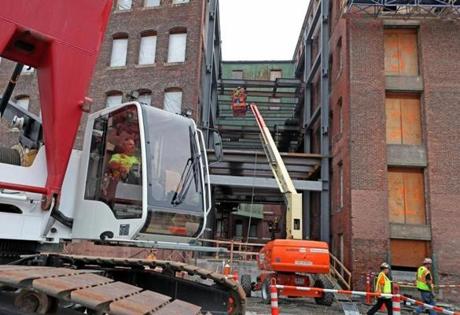 Work continued at the site of GE?s new headquarters in Fort Point in August.
