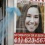 FILE - In this Aug. 21, 2018, file photo, a poster for missing University of Iowa student Mollie Tibbetts hangs in the window of a local business in Brooklyn, Iowa. Rob Tibbetts, father of slain Iowa college student Mollie Tibbetts in a Saturday, Sept. 1, opinion piece spoke out against using his daughter?s death ?to advance views she believed were profoundly racist,? a call that comes after President Donald Trump and others seized on the suspected killer?s citizenship to argue for changes in U.S. immigration laws. (AP Photo/Charlie Neibergall, File)