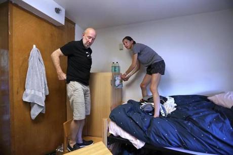 Zoe Willig, 18, of Seattle, prepared to hoist a bookcase in her Tufts University dorm room with the help of her stepfather, Jay Kornfeld.

