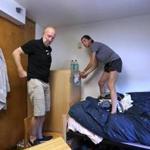 Zoe Willig, 18, of Seattle, prepared to hoist a bookcase in her Tufts University dorm room with the help of her stepfather, Jay Kornfeld.