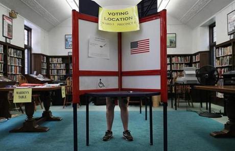 Newer polling booths have American flags on them at the Waban Library Center in Newton.
