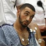 Emanuel Lopes is seated in a wheelchair during his arraignment in district court, Tuesday, July 17, 2018, in Quincy, Mass. Lopes, suspected of killing a Massachusetts police officer, as well as an innocent bystander, is being held without bail. (Greg Derr/The Quincy Patriot Ledger via AP, Pool)