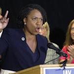 Ayanna Pressley, who won the Seventh Congressional District Democratic primary Tuesday, wore her signature lapel pin as she spoke at a Massachusetts Democratic Party unity event in Boston the following day.