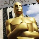 FILE - In this Feb. 21, 2015 file photo, an Oscar statue appears outside the Dolby Theatre for the 87th Academy Awards in Los Angeles. The organization that bestows the Academy Awards says it is suspending plans to award a new Oscar for popular films amid widespread backlash to the idea. The Academy of Motion Picture Arts and Sciences says Thursday that it will study plans for the category further. (Photo by Matt Sayles/Invision/AP, File)