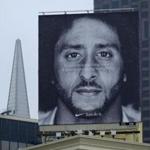 A large billboard stands on top of a Nike store showing former San Francisco 49ers quarterback Colin Kaepernick at Union Square, Wednesday, Sept. 5, 2018, in San Francisco. An endorsement deal between Nike and Colin Kaepernick prompted a flood of debate Tuesday as sports fans reacted to the apparel giant backing an athlete known mainly for starting a wave of protests among NFL players of police brutality, racial inequality and other social issues. (AP Photo/Eric Risberg)