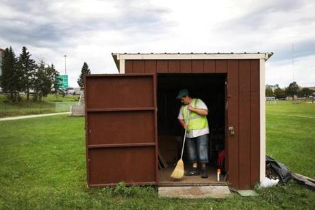 PORTLAND, ME - 08/30/2018 Peter Laroche sweeps out a tool shed while cleaning up garden beds along the Back Cove Trail while working for a city program that pays previous panhandlers minimum wage for cleaning up business lots and city parks. Erin Clark for The Boston Globe

