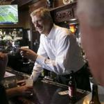 Governor Charlie Baker poured beers and chatted with patrons at the L Street Tavern on Sunday.