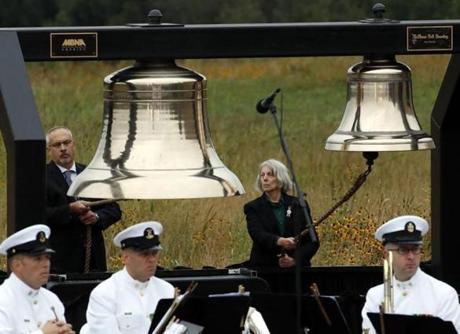 Bill Anders, left, and Sharon Custer ring bells as part of the Name Presentation and Ringing of Bells Remembrance during the September 11th Flight 93 Memorial Service in Shanksville, Pa., attended by President Donald Trump and first lady Melania Trump, Tuesday, Sept. 11, 2018. (AP Photo/Gene J. Puskar)
