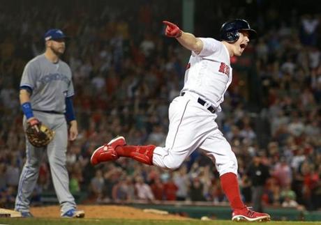 Boston, MA: 9-11-18: As he rounded first base, the Red Sox Brock Holt erupts as he sees his bottom of the seventh inning pinch hit three run home run clear the fence. The Boston Red Sox hosted the Toronto Blue Jays in a regular season MLB baseball game at Fenway Park. (Jim Davis/Globe Staff) 
