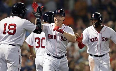 Boston, MA: 9-11-18: The Red Sox Brock Holt is all smiles as he heads for the dugout after his bottom of the seventh inning pinch hit three run home run. The Boston Red Sox hosted the Toronto Blue Jays in a regular season MLB baseball game at Fenway Park. (Jim Davis/Globe Staff)
