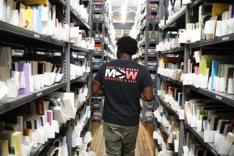 Mehki Jordan walked down an aisle in the internet and Web sales warehouse at the expanded More Than Words bookstore in the South End.
