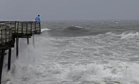 An onlooker checked out the heavy surf at the Avalon Fishing Pier in Kill Devil Hills, N.C., on Thursday as Hurricane Florence approached. 
