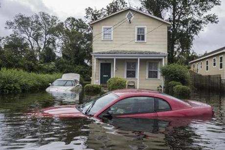 Cars and homes were surrounded by floodwaters in New Bern, N.C., on Saturday.

