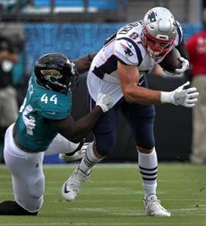 Jacksonville, FL - 9/16/2018 - (1st quarter) New England Patriots tight end Rob Gronkowski (87) is taken down by Jacksonville Jaguars linebacker Myles Jack (44) early in the first quarter. The Jacksonville Jaguars host the New England Patriots at TIAA Bank Field in Jacksonville, FL. - (Barry Chin/Globe Staff), Section: Sports, Reporter: Ben Volin, Topic: 17Patriots-Jaguars, LOID:8.4.3163038406.
