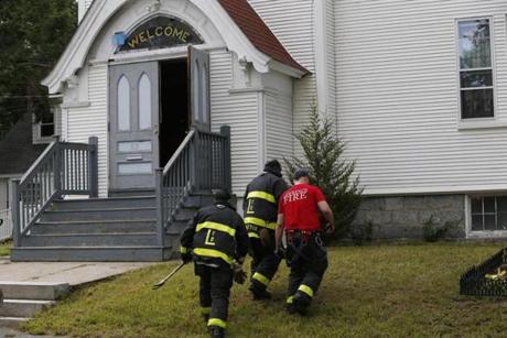 Firefighters checked on the Church of Christ in South Lawrence on Friday. 
