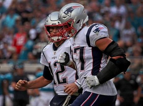 Jacksonville, FL - 9/16/2018 - (3rd quarter) New England Patriots quarterback Tom Brady (12) and New England Patriots tight end Rob Gronkowski (87) run off the field after a Brady to Hogan touchdown during the third quarter. The Jacksonville Jaguars host the New England Patriots at TIAA Bank Field in Jacksonville, FL. - (Barry Chin/Globe Staff), Section: Sports, Reporter: Ben Volin, Topic: 17Patriots-Jaguars, LOID:8.4.3163038406.
