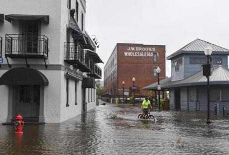 A bicyclist rode through South Water Street in Wilmington, N.C., Friday.  
