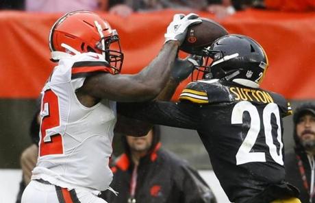 Cleveland Browns wide receiver Josh Gordon (12) catches a 17-yard touchdown pass under pressure from Pittsburgh Steelers cornerback Cameron Sutton (20) during the second half of an NFL football game, Sunday, Sept. 9, 2018, in Cleveland. (AP Photo/Ron Schwane)
