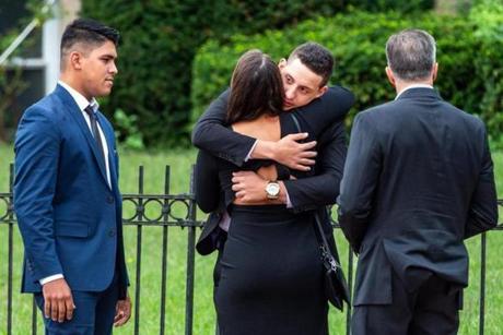 Isaac Rocha (center) hugged a friend during Wednesday?s funeral for Arthur Gava Medici in Saugus.
