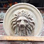 Crews carefully removed the lion's head from the Homans Building in Somerville as constuction of the MBTA Green Line extension continues.