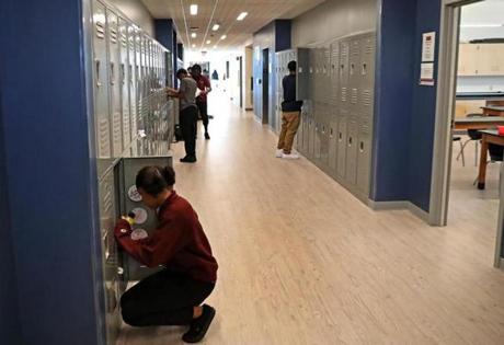 Students stopped at their lockers at the new Brooke High School and Eighth Grade Academy.
