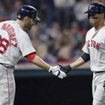 Boston Red Sox's Rafael Devers, right, is congratulated by J.D. Martinez after hitting a solo home run in the third inning of a baseball game against the Cleveland Indians, Saturday, Sept. 22, 2018, in Cleveland. (AP Photo/Tony Dejak)