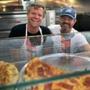Charlie Redd (left) and Keenan Langlois serve up pizza and kabobs in Somerville?s Davis Square.