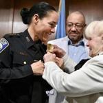BOSTON, 9/24/2018 - Nora Baston, who was named superintendent of a newly formed bureau of Community Engagement, is pinned with a badge representing her new rank by her adopted grandmother Ann Murphy, right, as her father Kent Murphy looks on during a ceremony at Boston Police Headquarters. Josh Reynolds for The Boston Globe (Metro, Desk ) 
