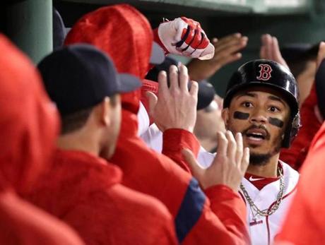 Boston MA 9/24/18 Boston Red Sox Mookie Betts is greeted with high fives in the dugout after hitting a 2 run home run against the Baltimore Orioles during second inning action at Fenway Park. (photo by Matthew J. Lee/Globe staff) topic: reporter: 
