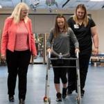 Susan Harkema (left), associate scientific director of the Kentucky Spinal Cord Injury Research Center at the University of Louisville, worked with Kelly Thomas, who was paralyzed in a car accident and is learning to walk with the help of a trainer and an implanted device.