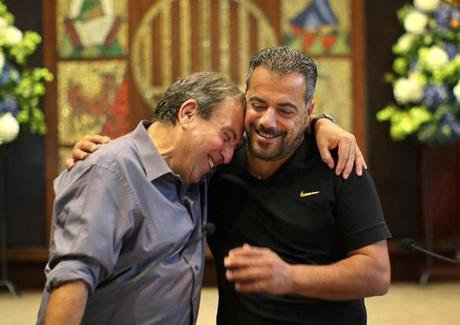 Rami Elhanan (left) and Mazen Faraj hugged Saturday in Boston.

