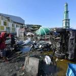 An overturned vehicle and debris lined the area Sunday in front of a collapsed mosque in Palu, on Indonesia?s Central Sulawesi island.