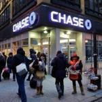 FILE - In this Jan. 14, 2015, file photo, people walk past a branch of Chase bank, in New York. JPMorgan Chase & Co. reports earnings Friday, April 13, 2018. (AP Photo/Mark Lennihan, File)
