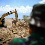 Indonesian soldiers buried victims of last week?s disaster in graves in Poboya on Tuesday. 