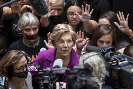 Sen. Elizabeth Warren, D-Mass., a vocal critic of Supreme Court nominee Brett Kavanaugh over the sexual harassment allegations made against him, greets womens' rights activists in the Hart Senate Office Building as the Senate Judiciary Committee hears from Kavanaugh and Christine Blasey Ford, his accuser, on Capitol Hill in Washington, Thursday, Sept. 27, 2018. (AP Photo/J. Scott Applewhite)
