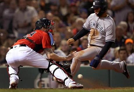 Boston, MA - 9/28/2018 - (4th inning) New York Yankees second baseman Gleyber Torres (25) scores ahead of the throw home to Boston Red Sox catcher Blake Swihart (23) to score during a 6 run fourth inning. The Boston Red Sox host the New York Yankees in Game 1 of a three game series at Fenway Park. - (Barry Chin/Globe Staff), Section: Sports, Reporter: Peter Abraham, Topic: 29Red Sox-Yankees, LOID:8.4.3302103597.
