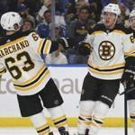 Boston Bruins forwards Brad Marchand (63) and David Pastrnak (88) celebrate a goal during the second period of the team's NHL hockey game against the Buffalo Sabres, Thursday, Oct. 4, 2018, in Buffalo N.Y. (AP Photo/Jeffrey T. Barnes)