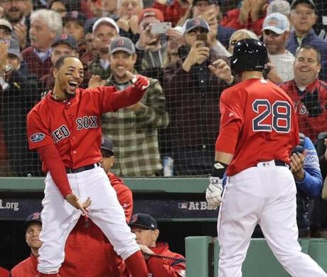 Boston, MA 10/05/18: Red Sox Mookie Betts greeted teammate J.D. Martinez after Martinez hit a three-run-home run in the first inning. Boston Red Sox hosted the New York Yankees in the first game of the ALDS at Fenway Park Friday, Oct. 5, 2018. (John Tlumacki/Globe Staff)
