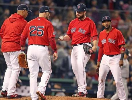 Boston MA: 10-05-18: Red Sox manager Alex Cora removes relief pitcher Ryan Brasier from the game in the top of the 6th inning. The Boston Red Sox hosted the New York Yankees in Game One of their MLB ALDS baseball playoffs. (Jim Davis/Globe Staff) 
