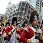 Reenactors Rob Lee (front, left) and Jeffery Meriwether (right) marched toward the Old State House. 