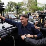 Jair Bolsonaro waved at supporters after casting his vote in Rio de Janeiro on Sunday.