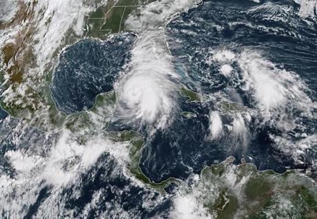 This NOAA/RAMMB satellite image taken on October 8, 2018 at 14:30 UTC shows Tropical storm Michael off the US Gulf Coast. - Tropical storm Michael was upgraded to a Category 1 hurricane on October 8, 2018 as it barreled toward the US Gulf Coast packing maximum sustained winds of 75 miles per hour, meteorologists said.The weather system was located between Mexico's Yucatan peninsula and the west coast of Cuba by 1500 GMT and was heading slowly towards the northern Gulf Coast of Florida, the National Hurricane Center in Miami said.It is expected to hit major hurricane strength and move inland over the Florida Panhandle or Florida Big Bend area on Wednesday, and then northeastward across the southeastern United States through Thursday. (Photo by HO / NOAA/RAMMB / AFP) / RESTRICTED TO EDITORIAL USE - MANDATORY CREDIT 