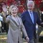 FILE - In this Nov. 8, 2016, file photo, Democratic presidential candidate Hillary Clinton, and her husband former President Bill Clinton, greet supporters after voting in Chappaqua, N.Y. The Clintons announced Monday, Oct. 8, 2018, they will visit four cities in 2018 and nine in 2019 across North America in a series of conversations dubbed ?An Evening with President Bill Clinton and former Secretary of State Hillary Rodham Clinton.