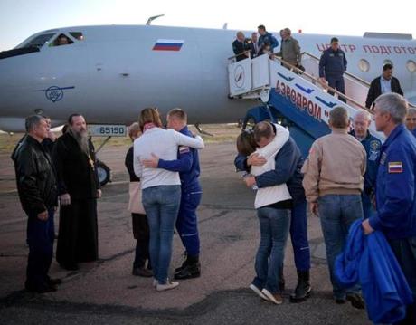In this image released by NASA, Expedition 57 Flight Engineer Alexey Ovchinin (C L) of Roscosmos, and Flight Engineer Nick Hague (C R) of NASA, embrace their families after landing at the Krayniy Airport on October 11, 2018, in Baikonur, Kazakhstan. Hague and Ovchinin arrived from Zhezkazgan after Russian Search and Rescue teams brought them from the Soyuz landing site. - The two-man crew of a Soyuz rocket made a successful emergency landing Thursday after an engine problem on lift-off to the International Space Station, in a major setback for the beleaguered Russian space industry. Hague and Russian Ovchinin were rescued without injuries in Kazakhstan. (Photo by Bill INGALLS / (NASA/Bill Ingalls) / AFP) / RESTRICTED TO EDITORIAL USE - MANDATORY CREDIT 