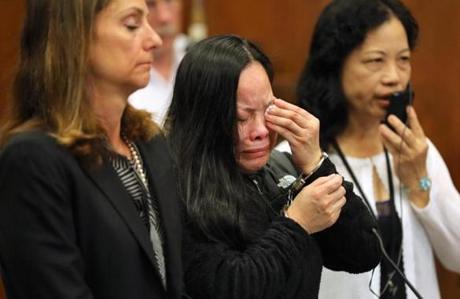 Xiao Ying Zhou (center) wept at her sentencing. Her lawyer, Michelle Troiano, is beside her.
